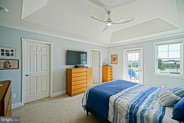 a bedroom with a bed and ceiling fan