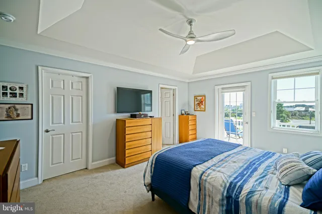 a bedroom with a bed and ceiling fan
