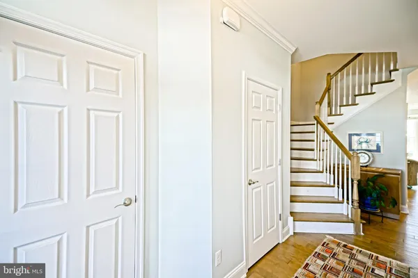 a kitchen with kitchen island granite countertop a table chairs sink and cabinets