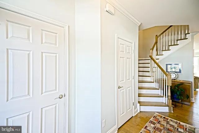 a kitchen with kitchen island granite countertop a table chairs sink and cabinets