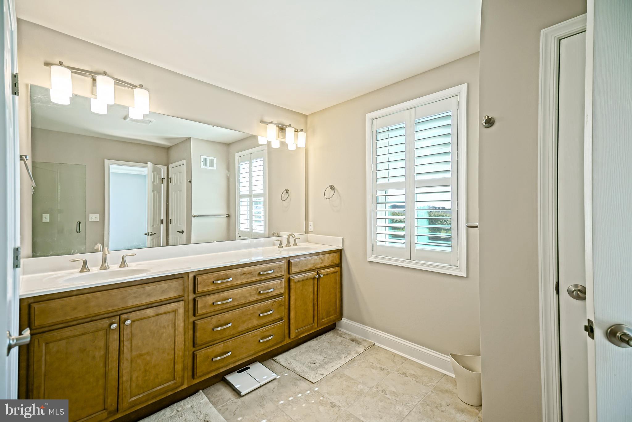31301 Temple Road Lewes, DE 19958 - Photo 31 of 64 a spacious bathroom with a granite countertop sink mirror and a
