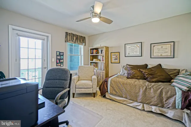 a bedroom with a bed and a large window