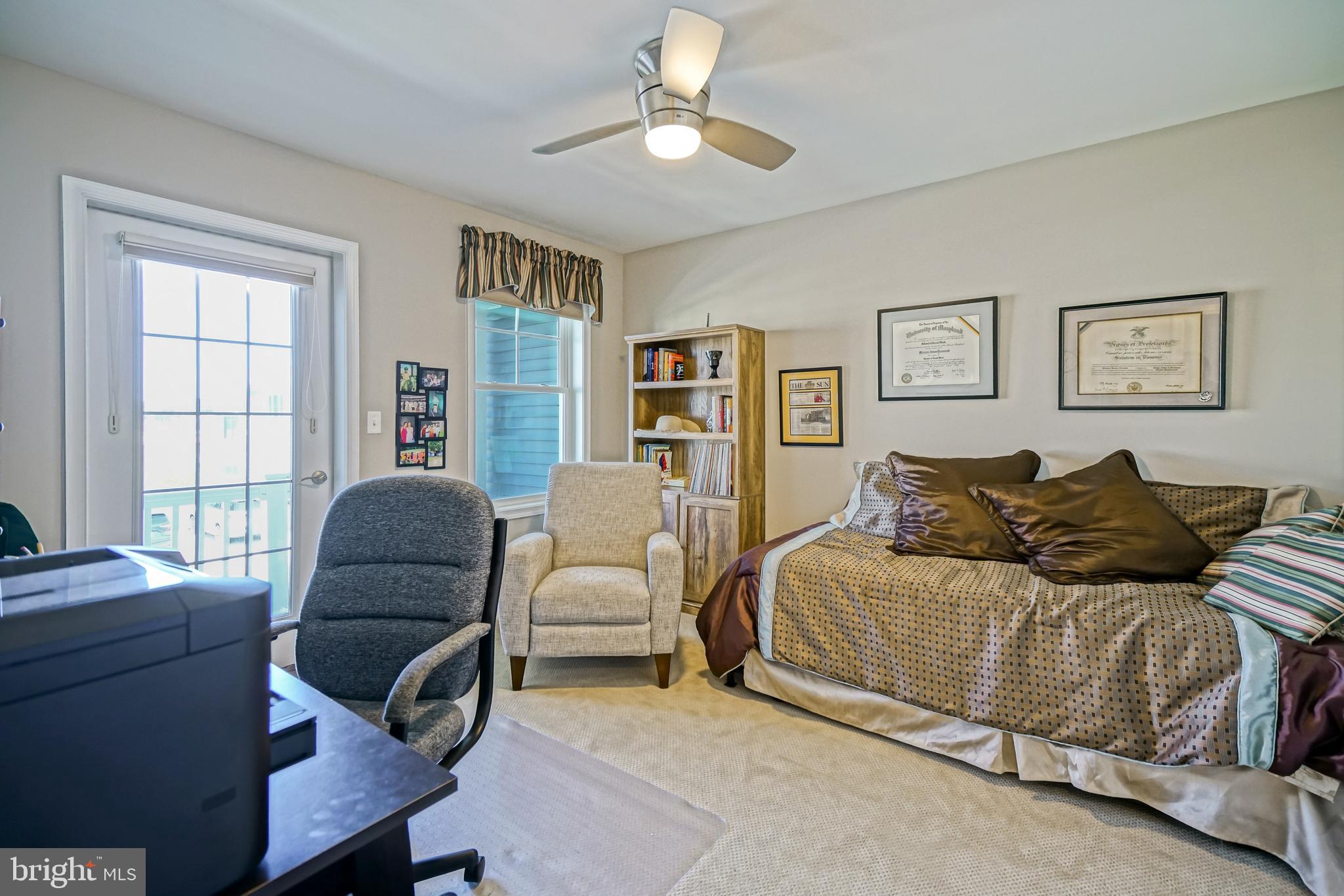 31301 Temple Road Lewes, DE 19958 - Photo 39 of 64 a living room with furniture ceiling fan and a window