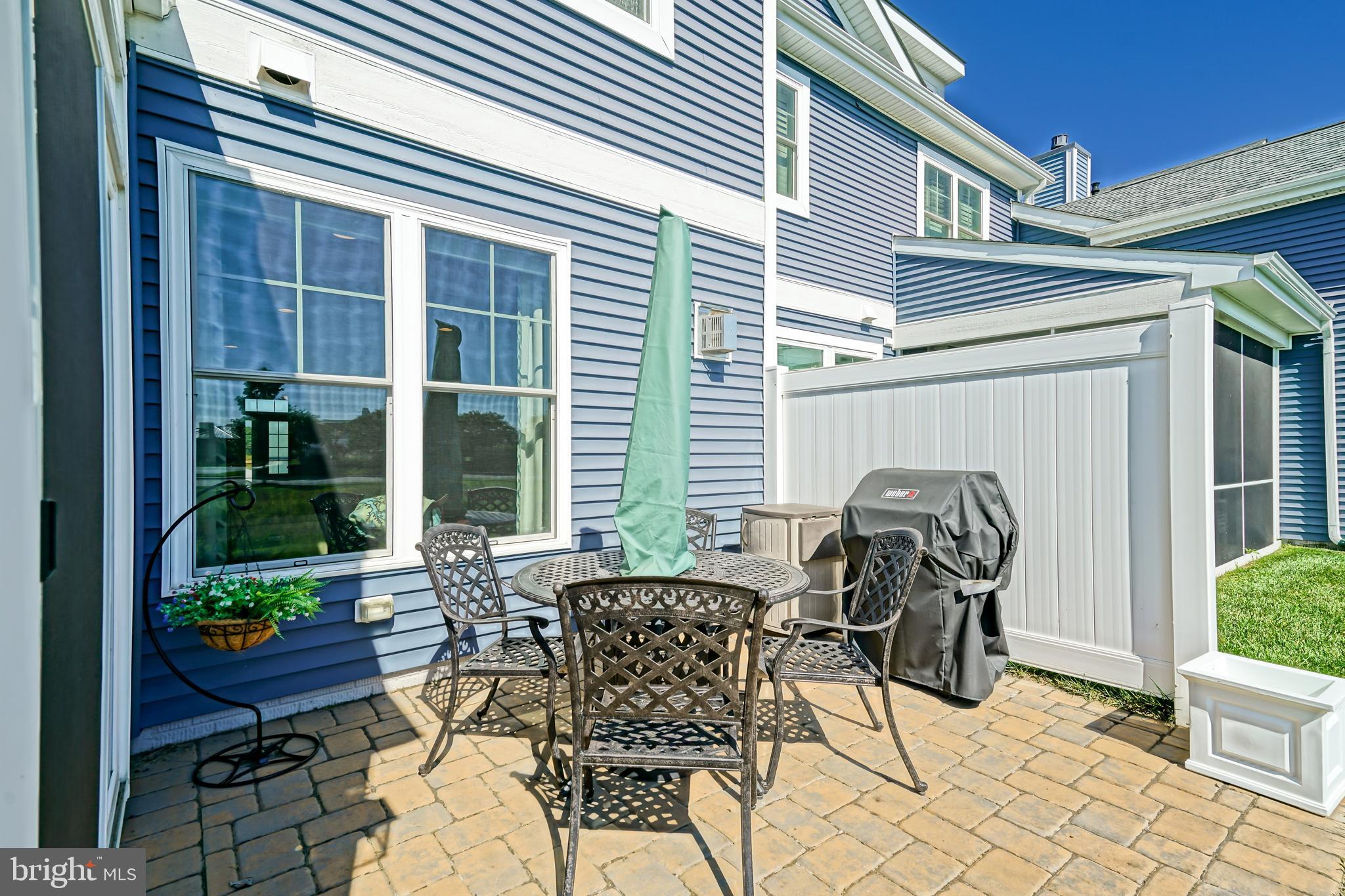 31301 Temple Road Lewes, DE 19958 - Photo 49 of 64 a view of a patio with table and chairs and potted plants