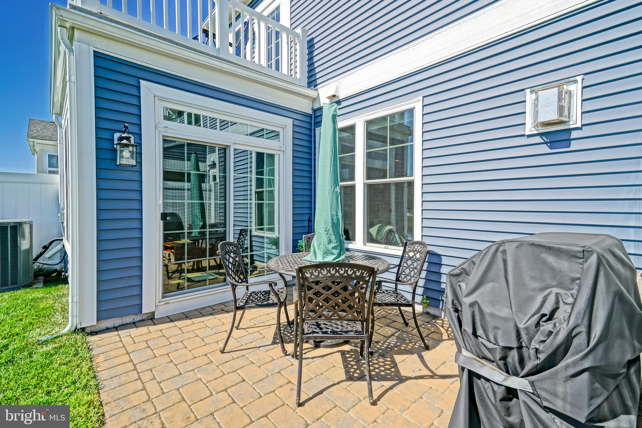 31301 Temple Road Lewes, DE 19958 - Photo 50 of 64 a patio with table and chairs and potted plants