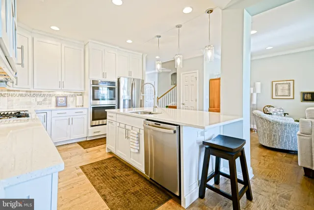 a kitchen that has a sink a stove and a refrigerator