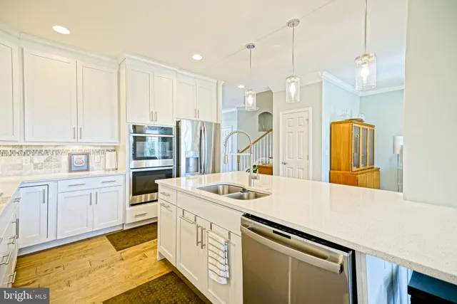a kitchen with stainless steel appliances granite countertop a refrigerator and a stove
