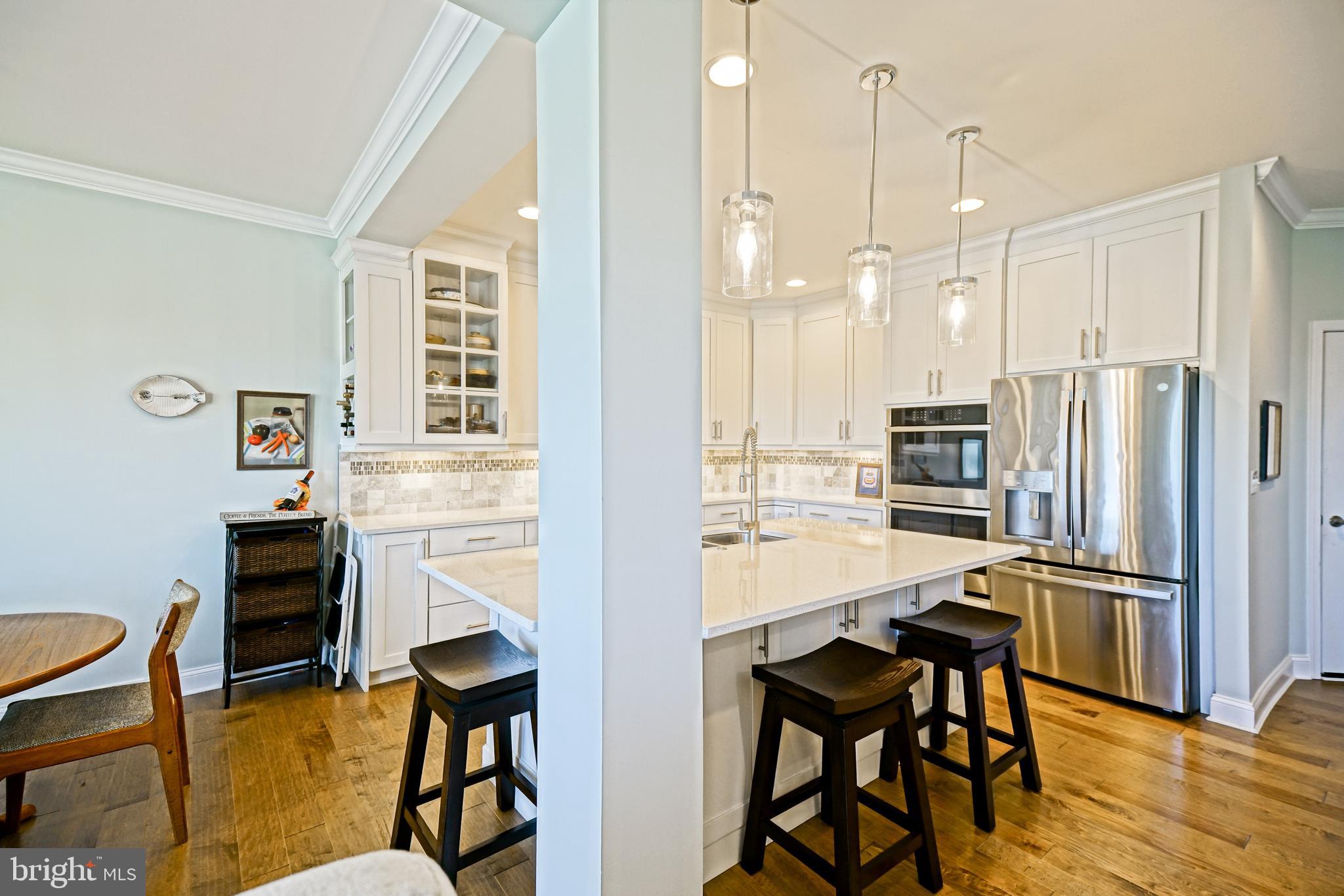 31301 Temple Road Lewes, DE 19958 - Photo 10 of 64 a kitchen with stainless steel appliances kitchen island granite countertop furniture and a refrigerator