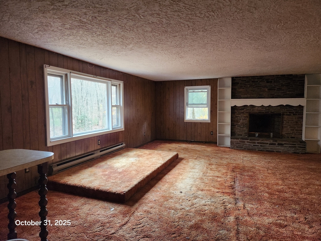 7 Pine Hill Road Grafton, MA 01560 - Photo 4 of 18 a bedroom with furniture and a fireplace
