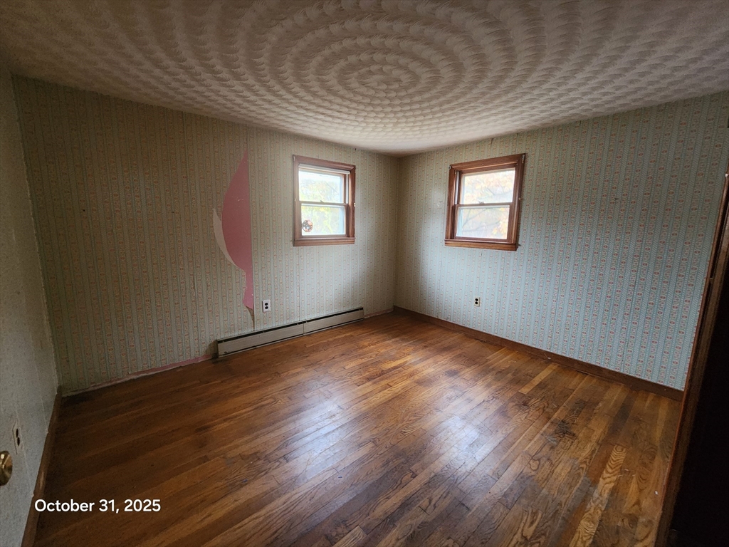 7 Pine Hill Road Grafton, MA 01560 - Photo 8 of 18 an empty room with wooden floor and windows