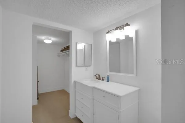 a bathroom with a sink vanity and mirror