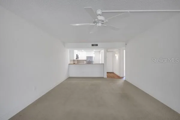 a view of a kitchen with a sink and cabinets