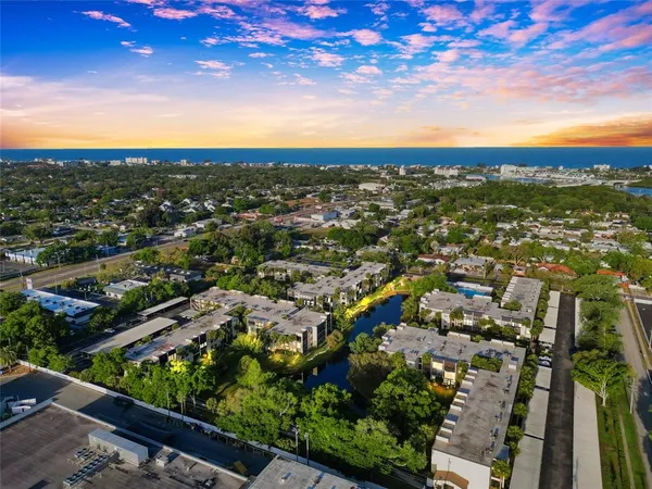 an aerial view of residential houses with city view