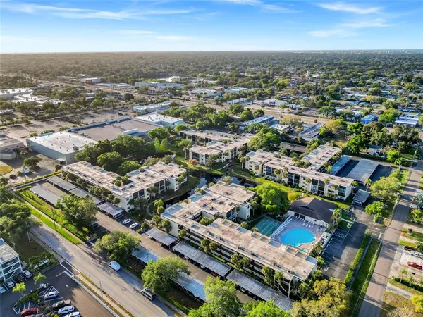 an aerial view of residential houses with city view