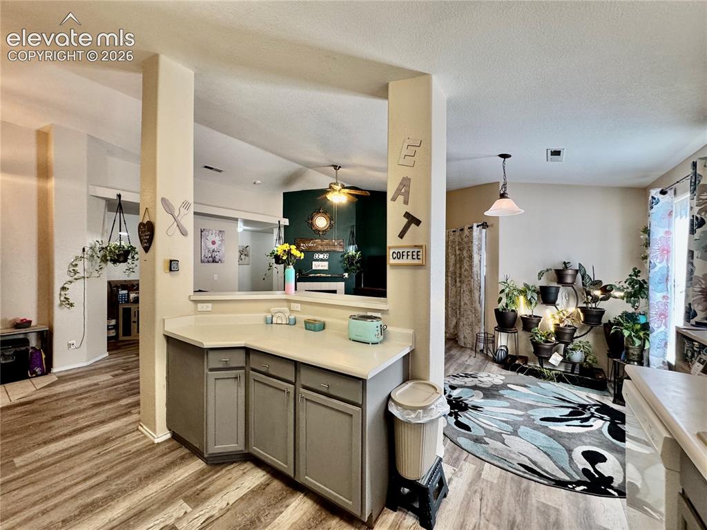 3748 Riviera Grove, Unit 203 Colorado Springs, CO 80922 - Photo 7 of 23 a kitchen that has a sink and a stove in it