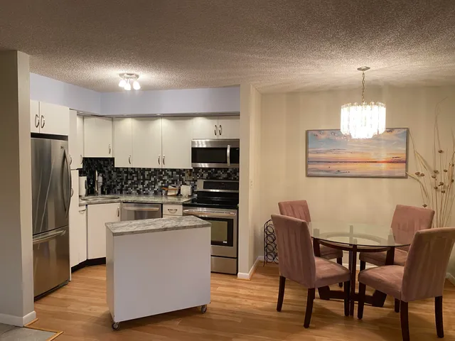 a kitchen with cabinets and stainless steel appliances