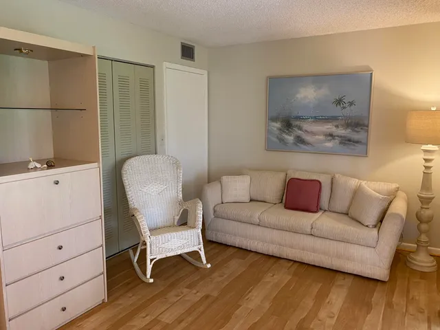 a living room with furniture and a chair