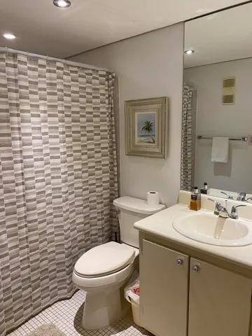 a bathroom with a sink a toilet and mirror