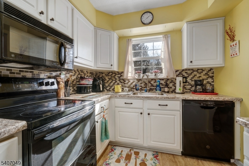 8 Lee Court Lebanon, NJ 08833 - Photo 11 of 20 a kitchen with stainless steel appliances a stove a sink a microwave cabinets and a window