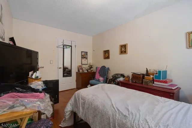 a bedroom with two beds and a flat screen tv