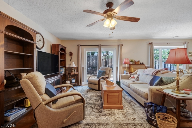 8 Lee Court Lebanon, NJ 08833 - Photo 7 of 20 a living room with furniture a flat screen tv and a large window