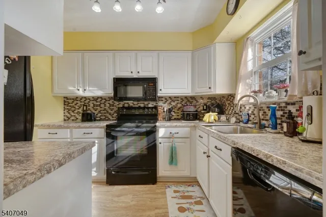 a kitchen with a sink stove and refrigerator