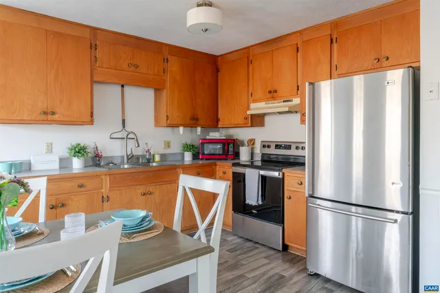 a kitchen with stainless steel appliances a refrigerator sink and cabinets