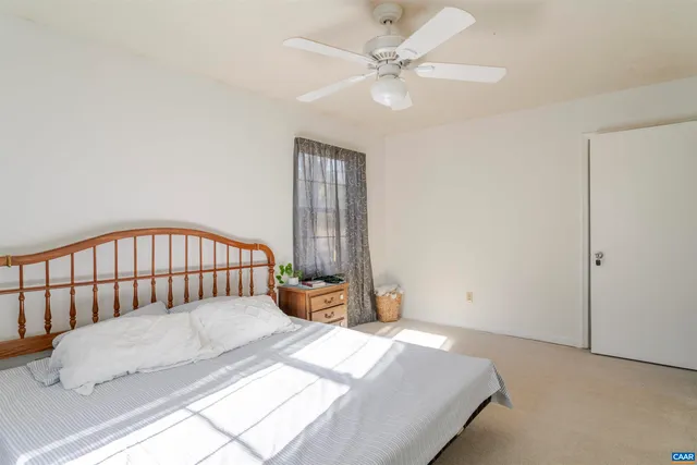 a bedroom with a bed and window