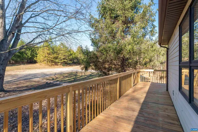 a view of a balcony with wooden floor and fence