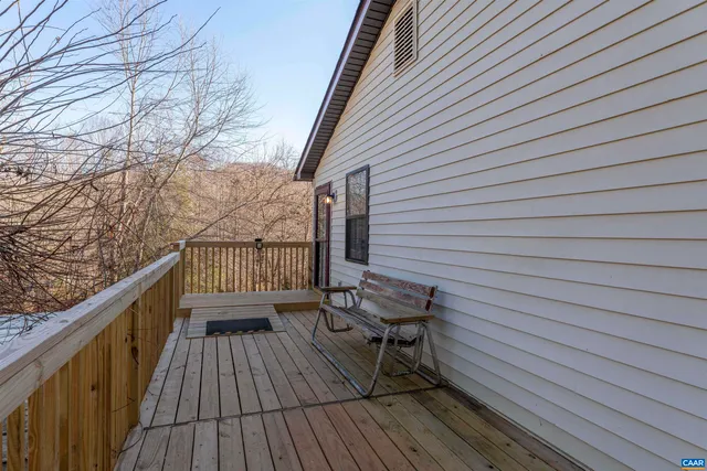 a view of deck with table and chairs and wooden floor