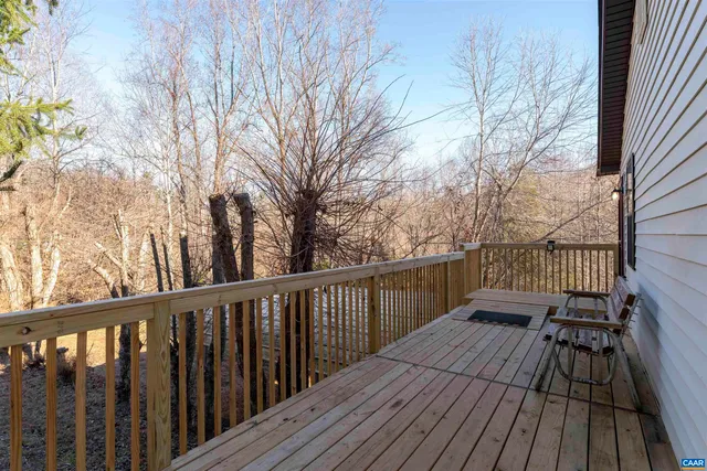 a view of balcony with wooden floor and fence