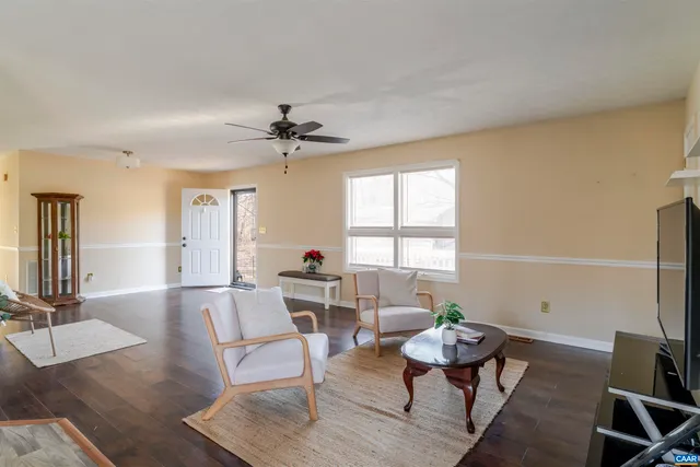 a living room with furniture a window and a table