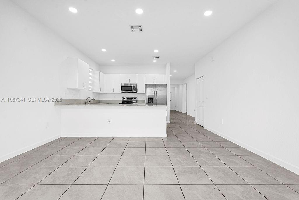 12735 Southwest 211th Street Miami, FL 33177 - Photo 2 of 34 a view of a kitchen with a sink and cabinets