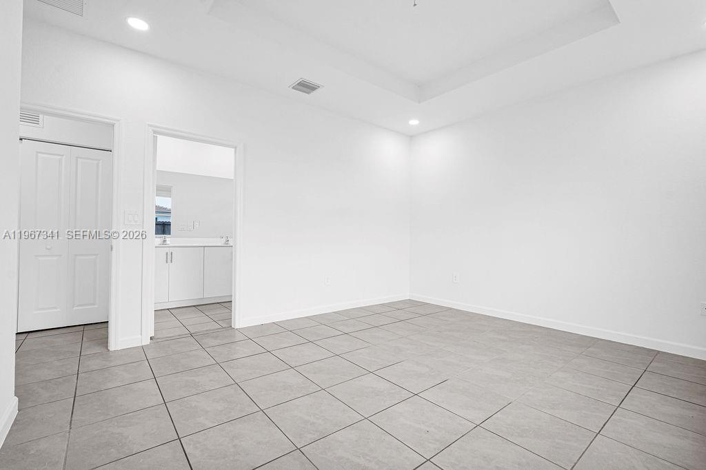 12735 Southwest 211th Street Miami, FL 33177 - Photo 24 of 34 an empty room with white walls