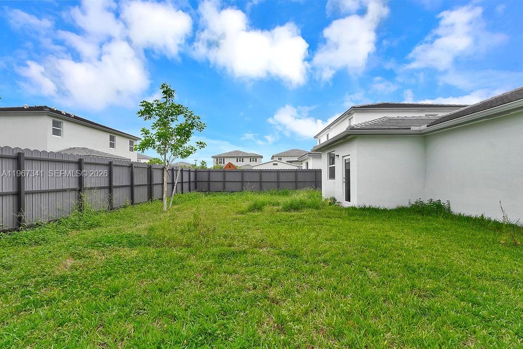 12735 Southwest 211th Street Miami, FL 33177 - Photo 32 of 34 a backyard of a house with lots of green space