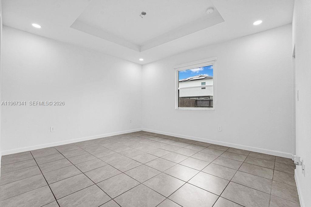 12735 Southwest 211th Street Miami, FL 33177 - Photo 6 of 34 an empty room with windows and cabinet