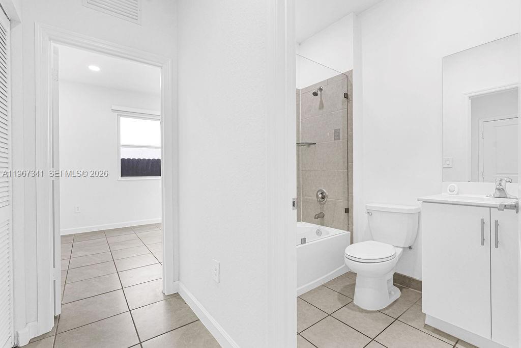 12735 Southwest 211th Street Miami, FL 33177 - Photo 7 of 34 a bathroom with a sink a toilet and shower