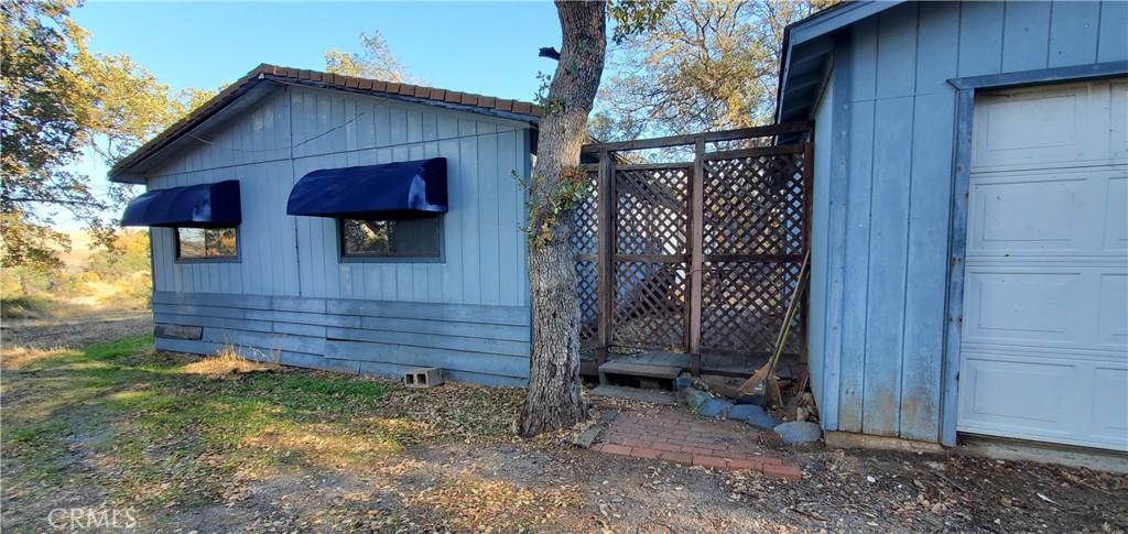 a view of a house with a wooden fence