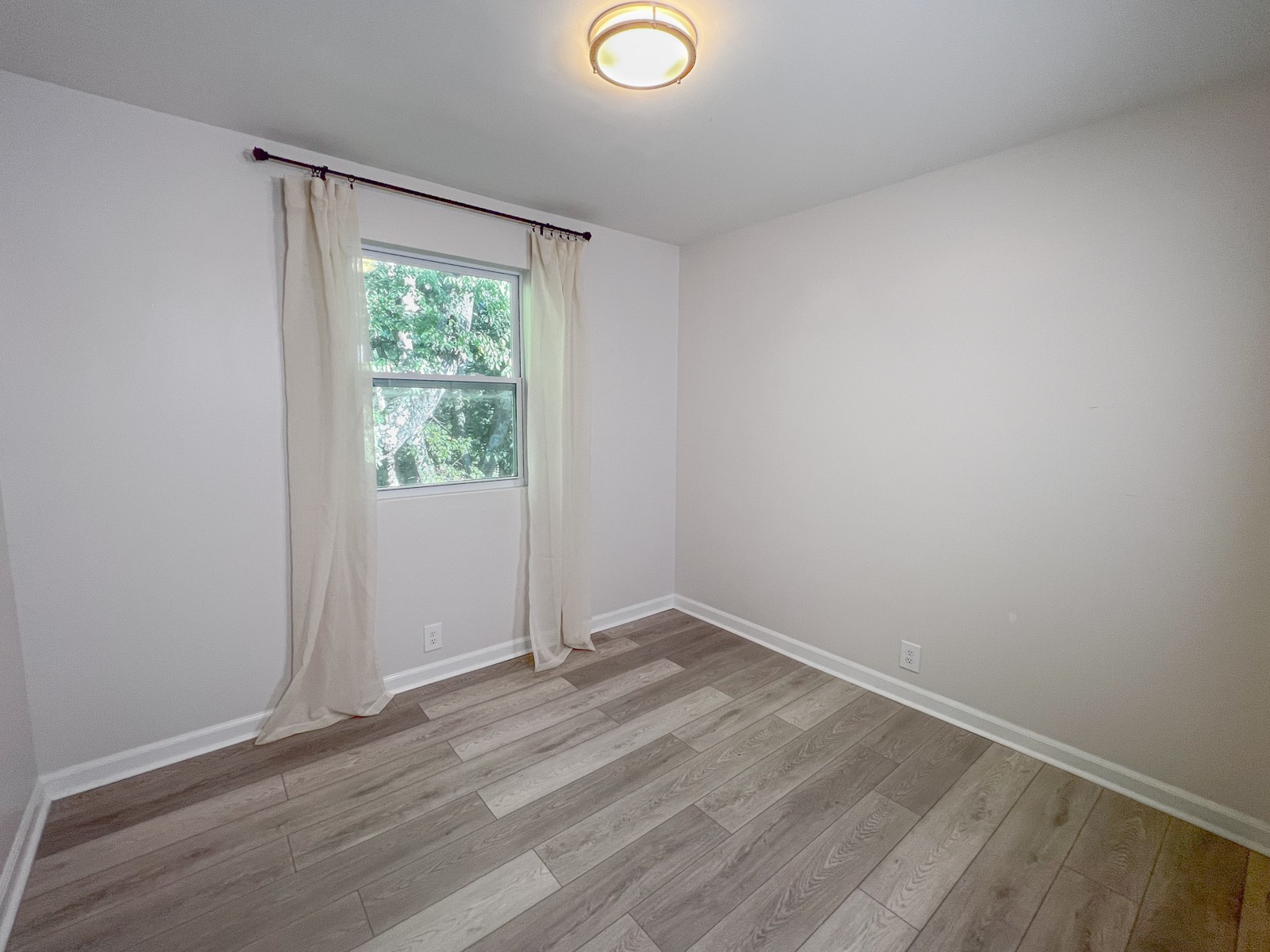 601 Boyd Mill Avenue, Unit G2 Franklin, TN 37064 - Photo 15 of 30 an empty room with wooden floor and windows