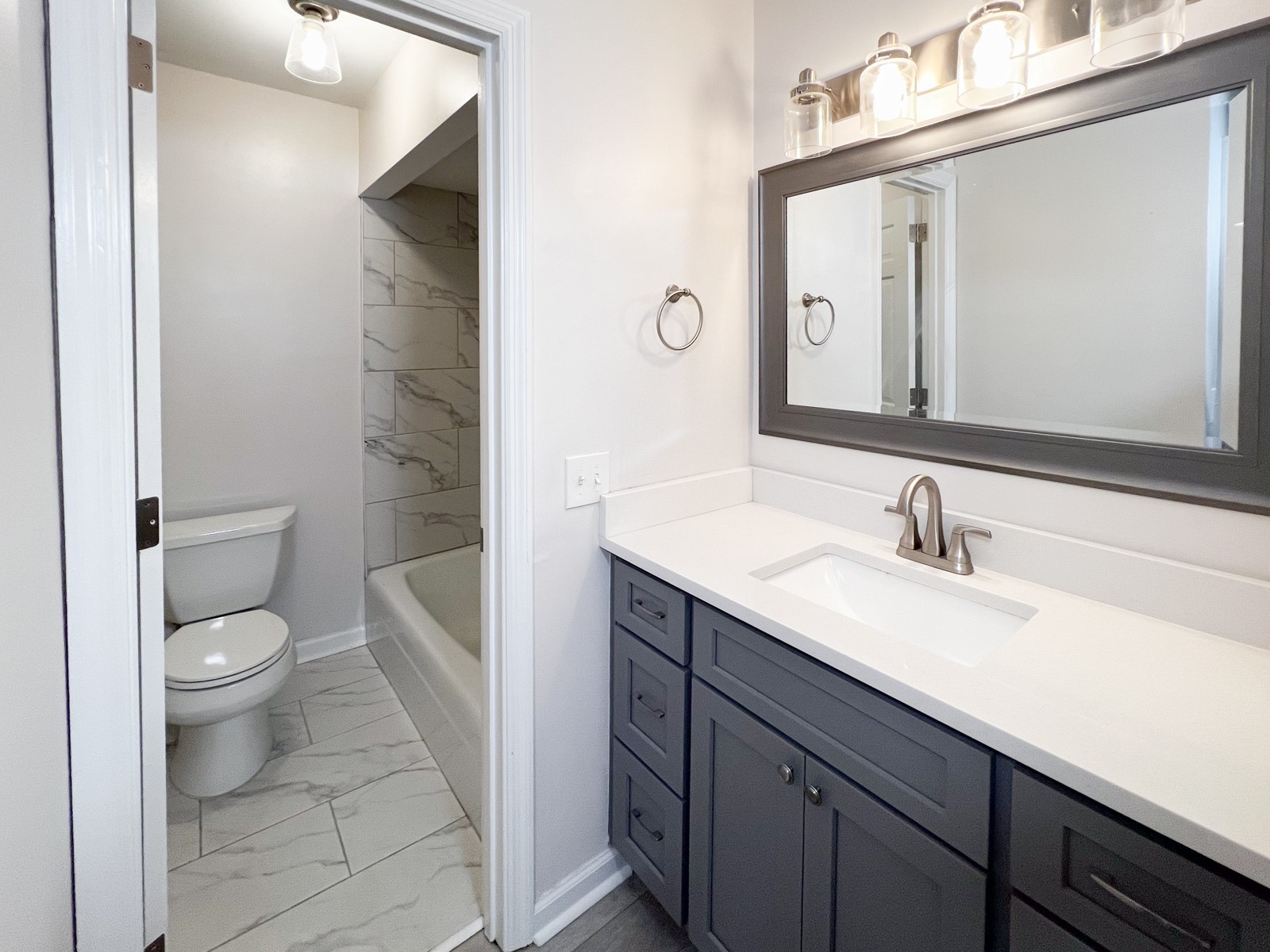601 Boyd Mill Avenue, Unit G2 Franklin, TN 37064 - Photo 18 of 30 a bathroom with a granite countertop sink a toilet and a mirror