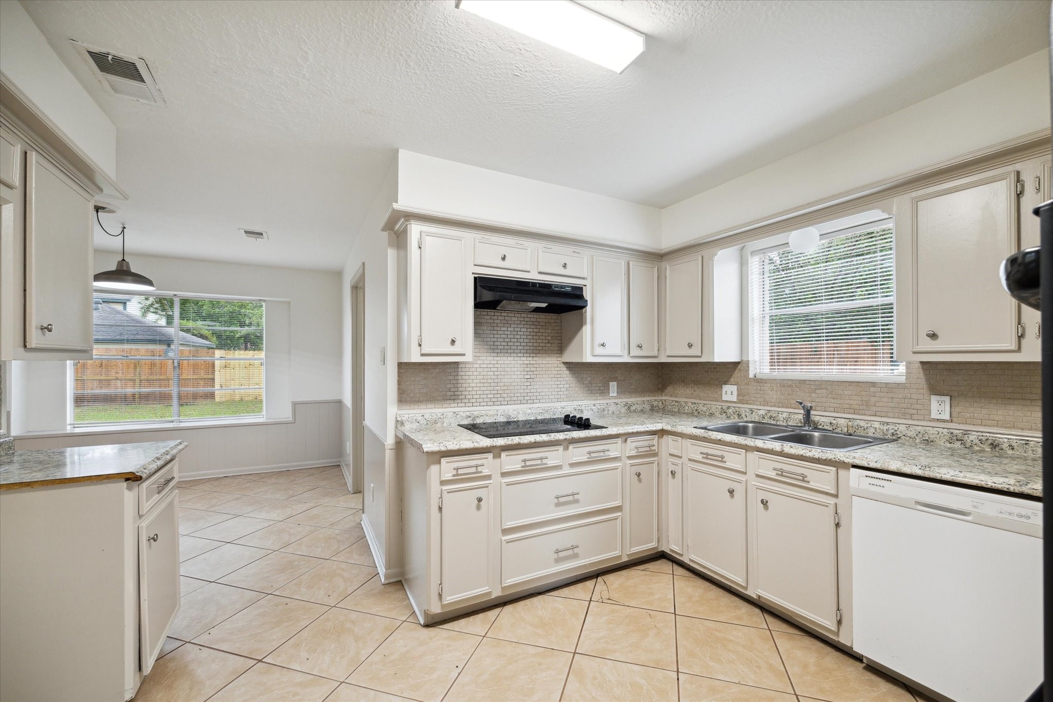10407 Rippling Fields Drive Houston, TX 77064 - Photo 5 of 17 Large open kitchen with tile floors and freshly painted cabinets.