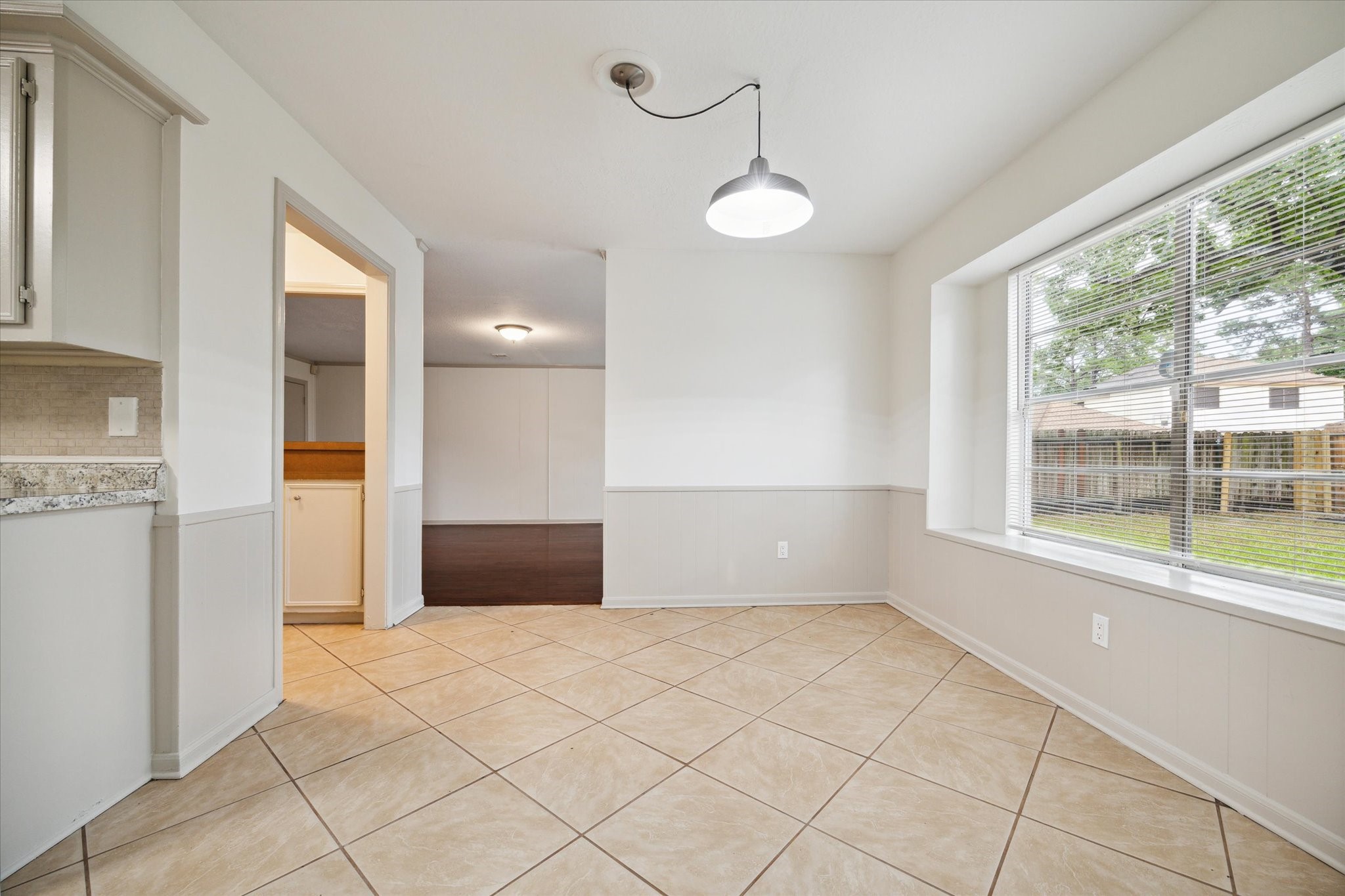 10407 Rippling Fields Drive Houston, TX 77064 - Photo 7 of 17 View of breakfast room with view into den an walk-in wet bar to the left.