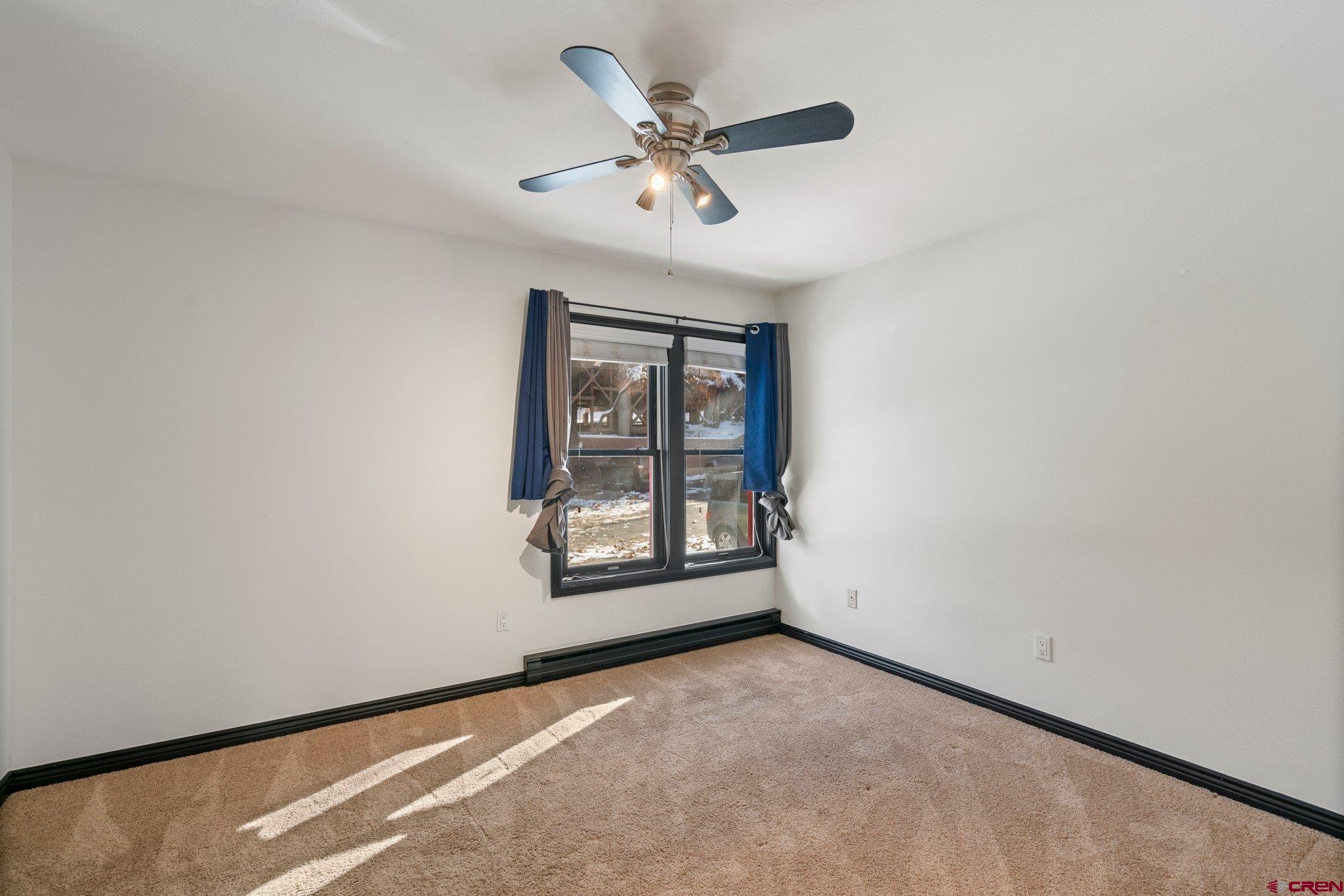 6 Ferringway Circle, Unit 44 Durango, CO 81301 - Photo 16 of 32 an empty room with windows and ceiling fan