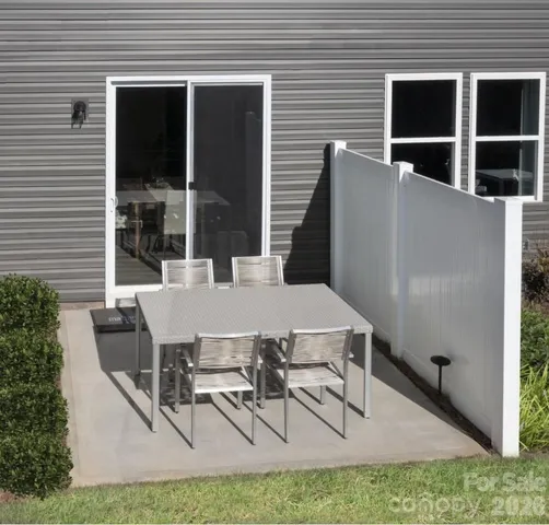 a view of a patio with table and chairs
