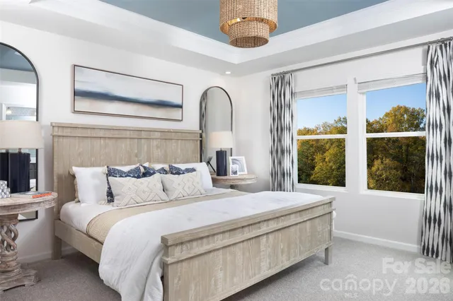 a bedroom with a large bed and a large window