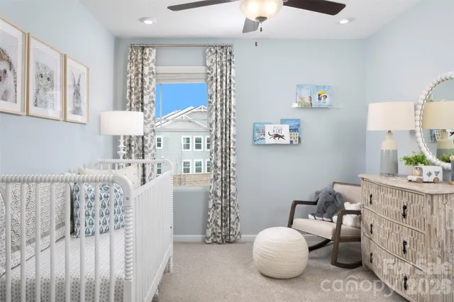 a bedroom with furniture and a large window