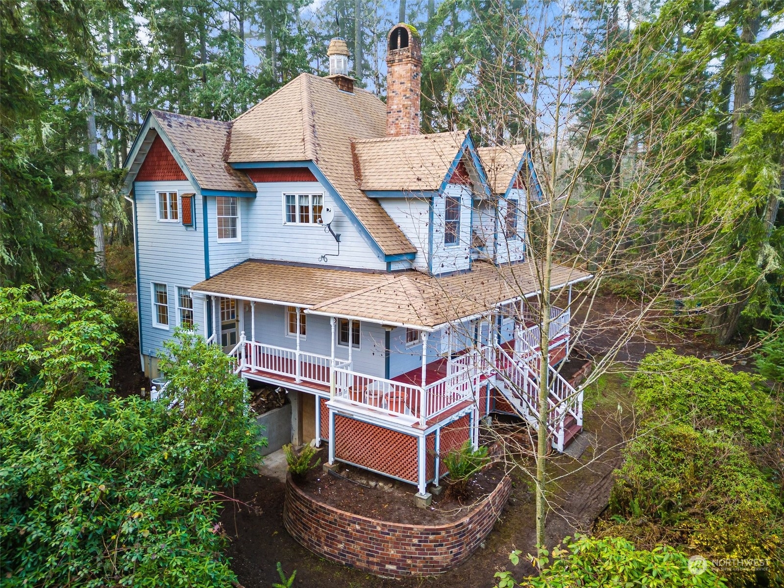 8120 Libby Road Northeast Olympia, WA 98506 - Photo 3 of 36 an aerial view of a house with a big yard and large trees
