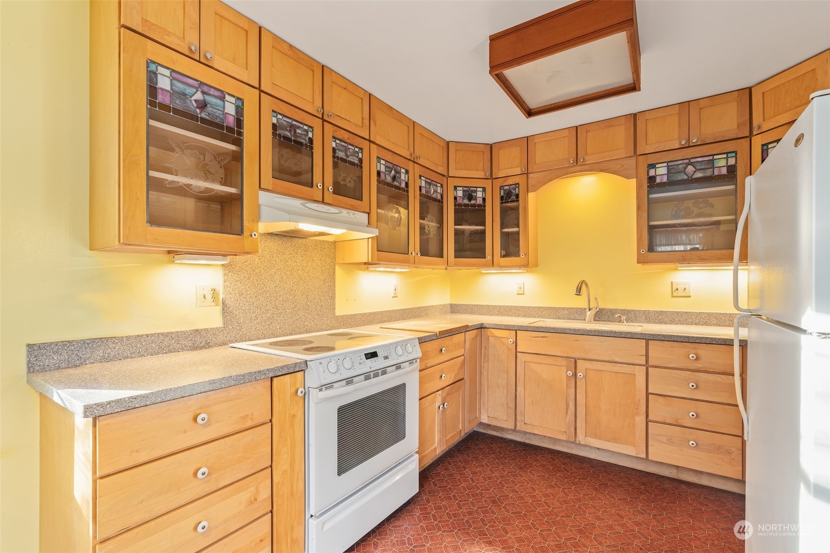 8120 Libby Road Northeast Olympia, WA 98506 - Photo 9 of 36 a kitchen with stainless steel appliances granite countertop a sink and cabinets with wooden floor