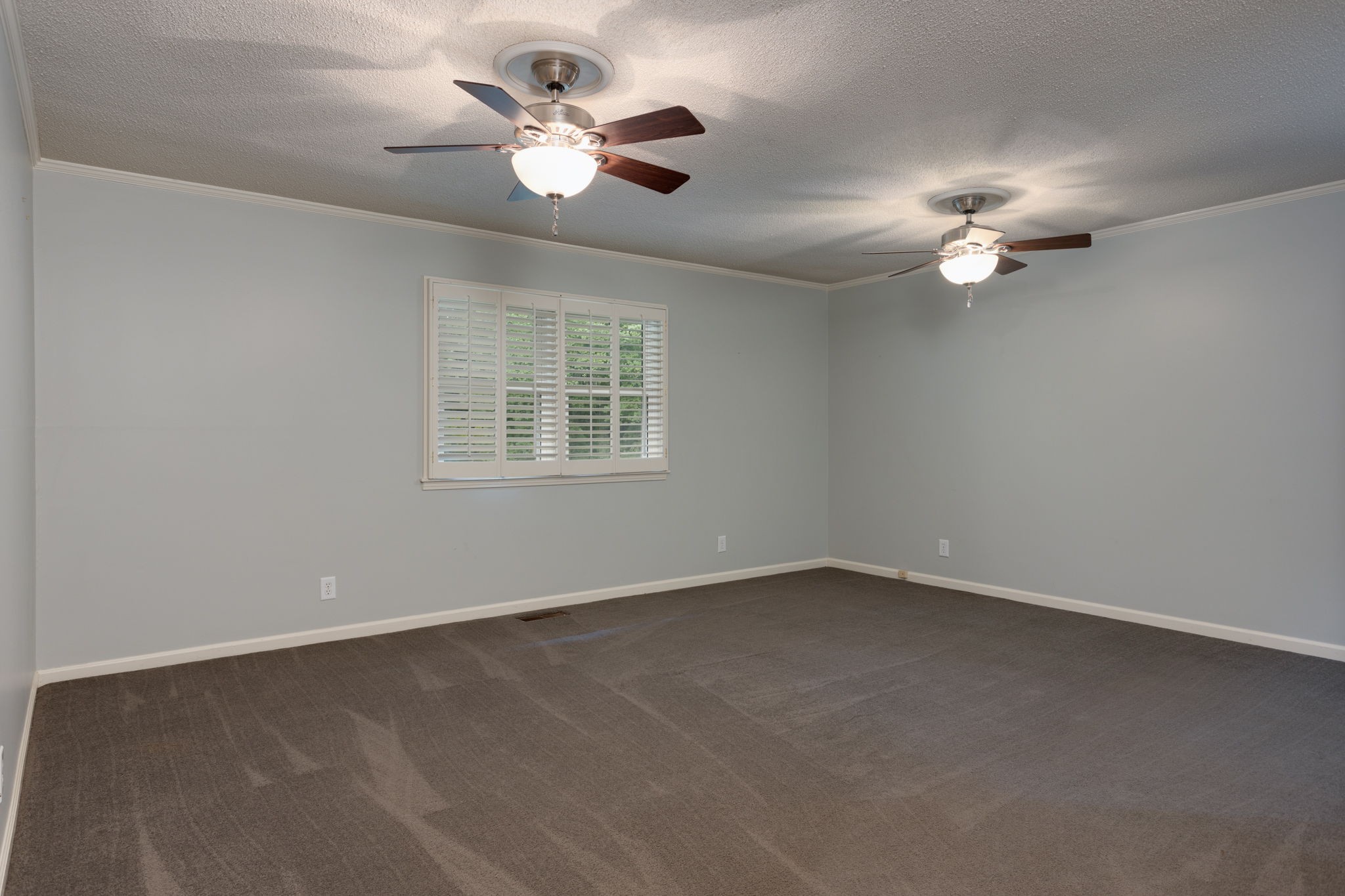 3557 Forest Park Road Springfield, TN 37172 - Photo 17 of 47 an empty room with a chandelier fan and windows