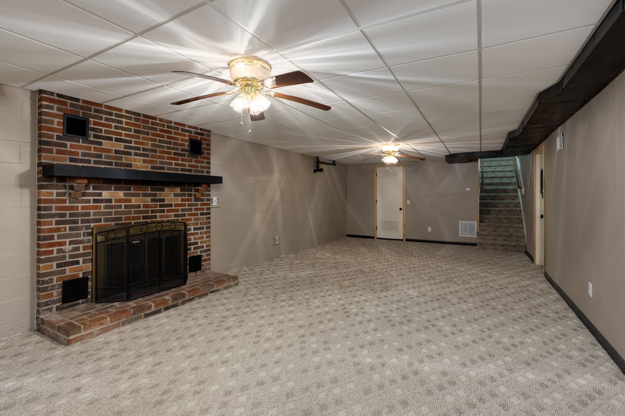 3557 Forest Park Road Springfield, TN 37172 - Photo 33 of 47 a view of a livingroom with a fireplace ceiling fan and stairs